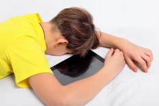 Tired Teenager With Tablet