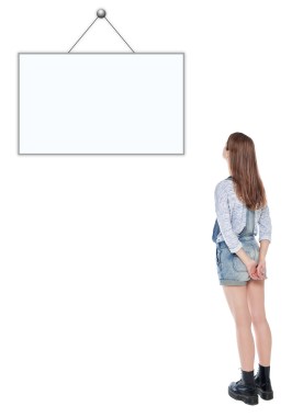 Young Teenage Girl Standing And Looking On Empty Picture Frame